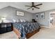 Comfortable bedroom featuring a ceiling fan, neutral walls, and carpet flooring at 10474 W Purgatoire Peak, Littleton, CO 80127