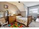 Charming bedroom featuring a wooden bed frame and colorful decor at 10474 W Purgatoire Peak, Littleton, CO 80127
