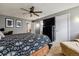 Cozy bedroom with a ceiling fan, TV, and neutral carpet flooring at 10474 W Purgatoire Peak, Littleton, CO 80127