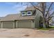 Two-car garage and well-maintained exterior showcasing a home with great curb appeal at 10474 W Purgatoire Peak, Littleton, CO 80127