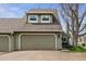 Attached two-car garage and well-maintained exterior showcasing a home with great curb appeal at 10474 W Purgatoire Peak, Littleton, CO 80127