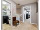 Hallway with a laundry room and view into a bedroom; neutral walls and carpet throughout at 10474 W Purgatoire Peak, Littleton, CO 80127