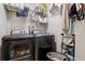 Laundry room featuring black washer and dryer and storage shelves at 10474 W Purgatoire Peak, Littleton, CO 80127