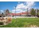 A community pool with red roofed buildings and a grassy area at 10474 W Purgatoire Peak, Littleton, CO 80127