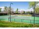 Well-maintained tennis courts surrounded by trees and blue skies for a great outdoor experience at 10474 W Purgatoire Peak, Littleton, CO 80127