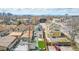 An aerial view captures the vibrant neighborhood, green backyards, and charming homes, with a distant skyline at 3050 N Marion St, Denver, CO 80205