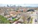 An aerial view displays a city neighborhood with a cityscape and glimpses of charming houses at 3050 N Marion St, Denver, CO 80205