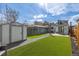Well-maintained backyard features artificial turf, detached garage, and storage shed at 3050 N Marion St, Denver, CO 80205
