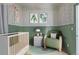 Charming Bedroom boasts wainscoting, a modern crib, and a cozy green rocking chair at 3050 N Marion St, Denver, CO 80205