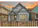 Charming craftsman-style home featuring unique architectural details, a cozy front porch, and a picket fence at 3050 N Marion St, Denver, CO 80205
