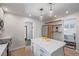 Spacious kitchen featuring stainless steel appliances, an island with white countertop, and a small office area at 3050 N Marion St, Denver, CO 80205