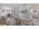 Open-concept living room featuring hardwood floors and neutral tones, leading to a dining area at 3050 N Marion St, Denver, CO 80205