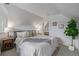 Cozy main bedroom with a sloped ceiling, neutral decor, and access to the ensuite bathroom at 3050 N Marion St, Denver, CO 80205