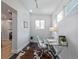 Bright home office featuring a glass desk, modern chair, and great light from two windows at 3050 N Marion St, Denver, CO 80205