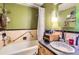 Functional bathroom featuring a bathtub with shower, vanity, and tiled walls at 2115 E 14Th Ave # 8, Denver, CO 80206
