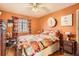 Comfortable bedroom with natural light, colorful bedding, and a ceiling fan at 2115 E 14Th Ave # 8, Denver, CO 80206