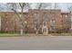 Traditional brick apartment building featuring a symmetrical design and mature landscaping at 2115 E 14Th Ave # 8, Denver, CO 80206