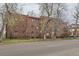 Classic brick apartment building showcasing symmetrical design, mature trees, and street view at 2115 E 14Th Ave # 8, Denver, CO 80206