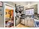 Compact kitchen adjacent to the dining area, equipped with stainless steel appliances at 2115 E 14Th Ave # 8, Denver, CO 80206