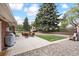 Beautiful backyard featuring a patio, mature trees, landscaping, and space for outdoor activities at 10525 W 18Th Ave, Lakewood, CO 80215