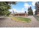 Large backyard with a patio, landscaping, and mature trees, offering a peaceful retreat at 10525 W 18Th Ave, Lakewood, CO 80215