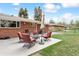 Outdoor patio perfect for relaxing and dining, surrounded by lawn and mature trees at 10525 W 18Th Ave, Lakewood, CO 80215