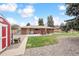 Spacious backyard with patio, shed, and lush lawn, perfect for recreation and outdoor living at 10525 W 18Th Ave, Lakewood, CO 80215