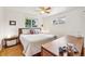 Bright bedroom with hardwood floors, ceiling fan, and lots of natural light from two windows at 10525 W 18Th Ave, Lakewood, CO 80215