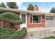 Inviting front entrance with brick facade, manicured landscaping, and a visible street address at 10525 W 18Th Ave, Lakewood, CO 80215