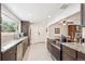 Bright kitchen featuring modern appliances, stone countertops, and an open view into the dining and living areas at 10525 W 18Th Ave, Lakewood, CO 80215