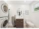 Bright laundry room featuring a stackable washer and dryer, vanity, and ample natural light at 10525 W 18Th Ave, Lakewood, CO 80215