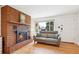 Cozy living room with a brick fireplace, hardwood floors, and a comfortable sofa at 10525 W 18Th Ave, Lakewood, CO 80215