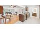 Open concept living space with a kitchen island, dining area, and living room with hardwood floors at 10525 W 18Th Ave, Lakewood, CO 80215