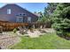 Backyard with a stone fire pit and Adirondack chairs in a private fenced in area at 8229 Cottongrass Ct, Castle Pines, CO 80108