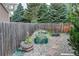 Backyard with raised garden beds, a wooden fence, and a stone pathway among the gravel at 8229 Cottongrass Ct, Castle Pines, CO 80108