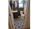 Stylish half-bathroom with geometric floor tiles, modern vanity, and decor at 8229 Cottongrass Ct, Castle Pines, CO 80108