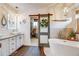 Stylish bathroom with barn door, freestanding tub, and modern vanity with vessel sinks at 8229 Cottongrass Ct, Castle Pines, CO 80108