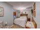 Charming bedroom featuring a decorative chandelier, a plush bed, and stylish rustic accents at 8229 Cottongrass Ct, Castle Pines, CO 80108