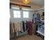 Spacious walk-in closet with ample hanging space and natural light for organized storage at 8229 Cottongrass Ct, Castle Pines, CO 80108
