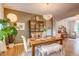 Elegant dining room featuring a wooden table, stylish chandelier, and adjacent sitting area at 8229 Cottongrass Ct, Castle Pines, CO 80108