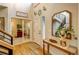 Inviting entryway with hardwood floors, stylish mirror, and views into adjacent rooms at 8229 Cottongrass Ct, Castle Pines, CO 80108