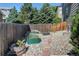 Backyard garden with garden beds and a gravel pathway, fenced in a private area at 8229 Cottongrass Ct, Castle Pines, CO 80108