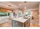 Bright kitchen with a large island with seating and a breakfast nook with backyard views at 8229 Cottongrass Ct, Castle Pines, CO 80108