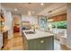 Bright kitchen boasts a large island with seating, stainless steel appliances, and a cozy breakfast nook at 8229 Cottongrass Ct, Castle Pines, CO 80108