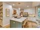 Bright kitchen with a large island with seating, stainless steel appliances, and white cabinetry at 8229 Cottongrass Ct, Castle Pines, CO 80108
