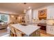 Stylish kitchen featuring an island with seating, stainless steel appliances, and an open view of the living area at 8229 Cottongrass Ct, Castle Pines, CO 80108