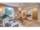 Bright living room featuring comfortable seating, a decorative fireplace, and large windows with natural light at 8229 Cottongrass Ct, Castle Pines, CO 80108