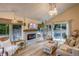 Cozy living room with a fireplace, comfortable seating, and access to the backyard patio at 8229 Cottongrass Ct, Castle Pines, CO 80108