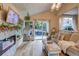Inviting living room featuring a fireplace, hanging chair, and views of the backyard at 8229 Cottongrass Ct, Castle Pines, CO 80108