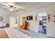 Spacious main bedroom with a ceiling fan, TV, and ensuite bathroom at 8229 Cottongrass Ct, Castle Pines, CO 80108
